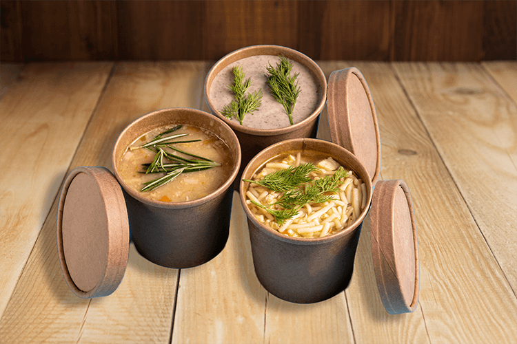 variety of cups of soup on wooden background bar