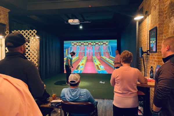 Group enjoying golf simulator skee ball mini games | Decatur IL
