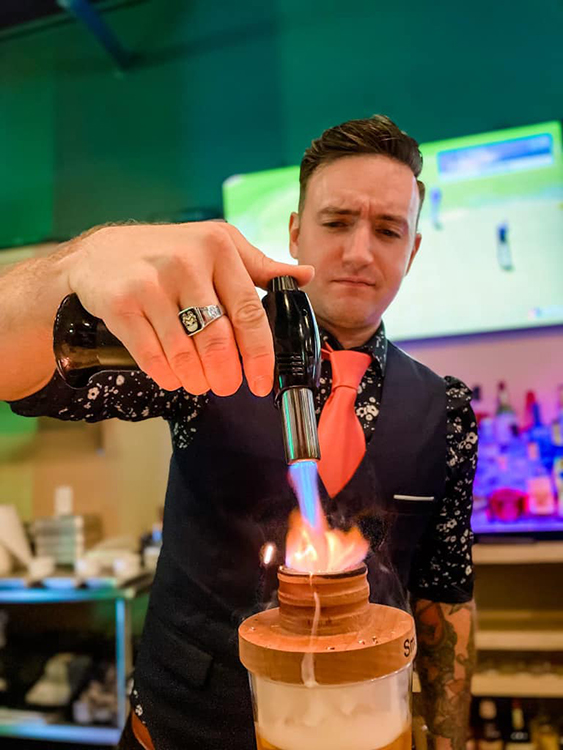 Caddy Shack Golf Pub | bar tender with culinary blow-torch creating exciting cocktail | Decatur IL